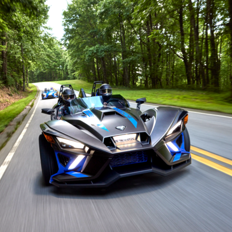 Slingshot 3 wheeled motorcycle races down a street